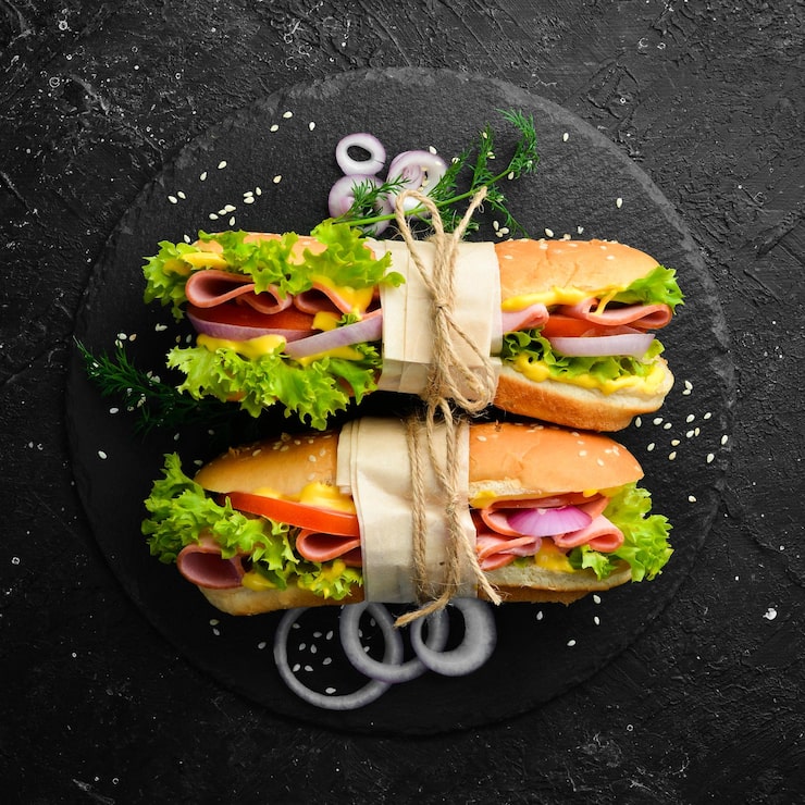 sandwich-with-sausage-cheese-lettuce-street-food-top-view-free-copy-space_187166-27476